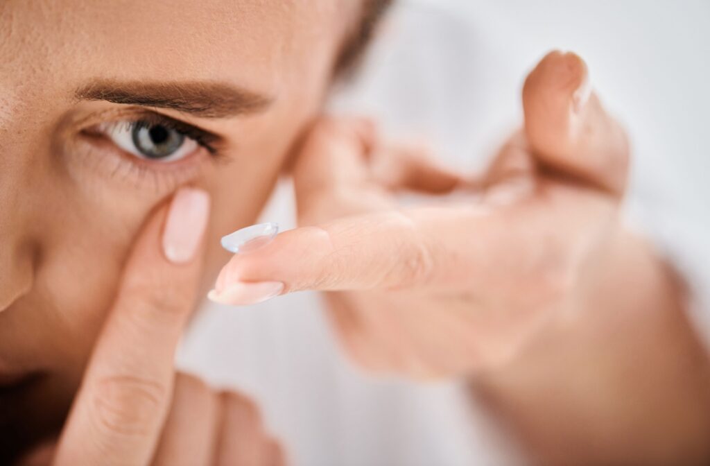 Close up of woman putting in contact lens.