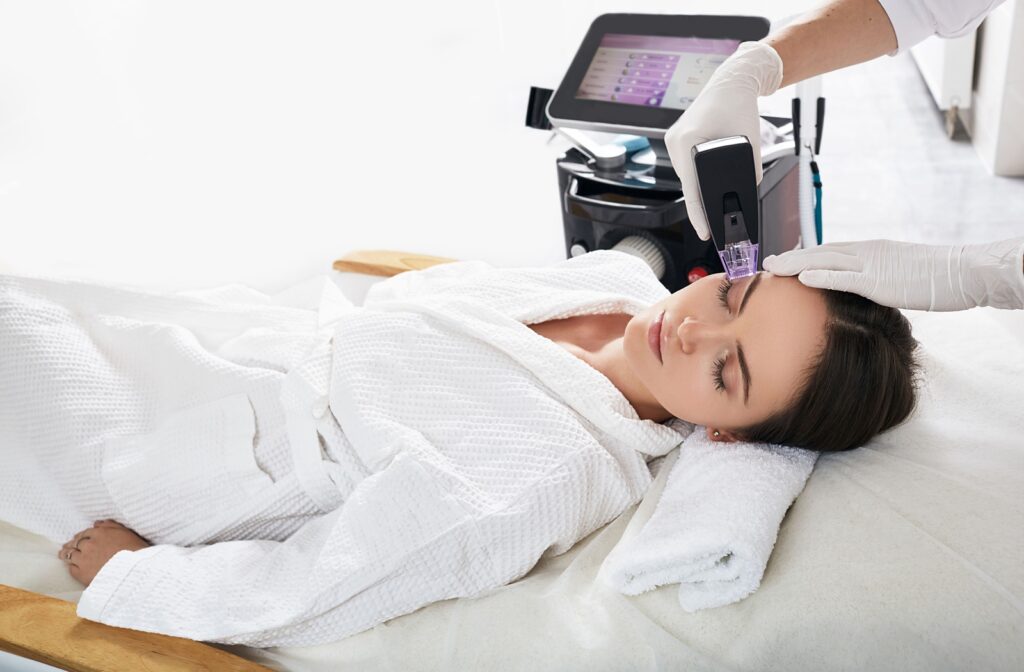 An optometrist using the Morpheus8 device around their patients' eyes to target and improve dry eye symptoms and skin concerns.